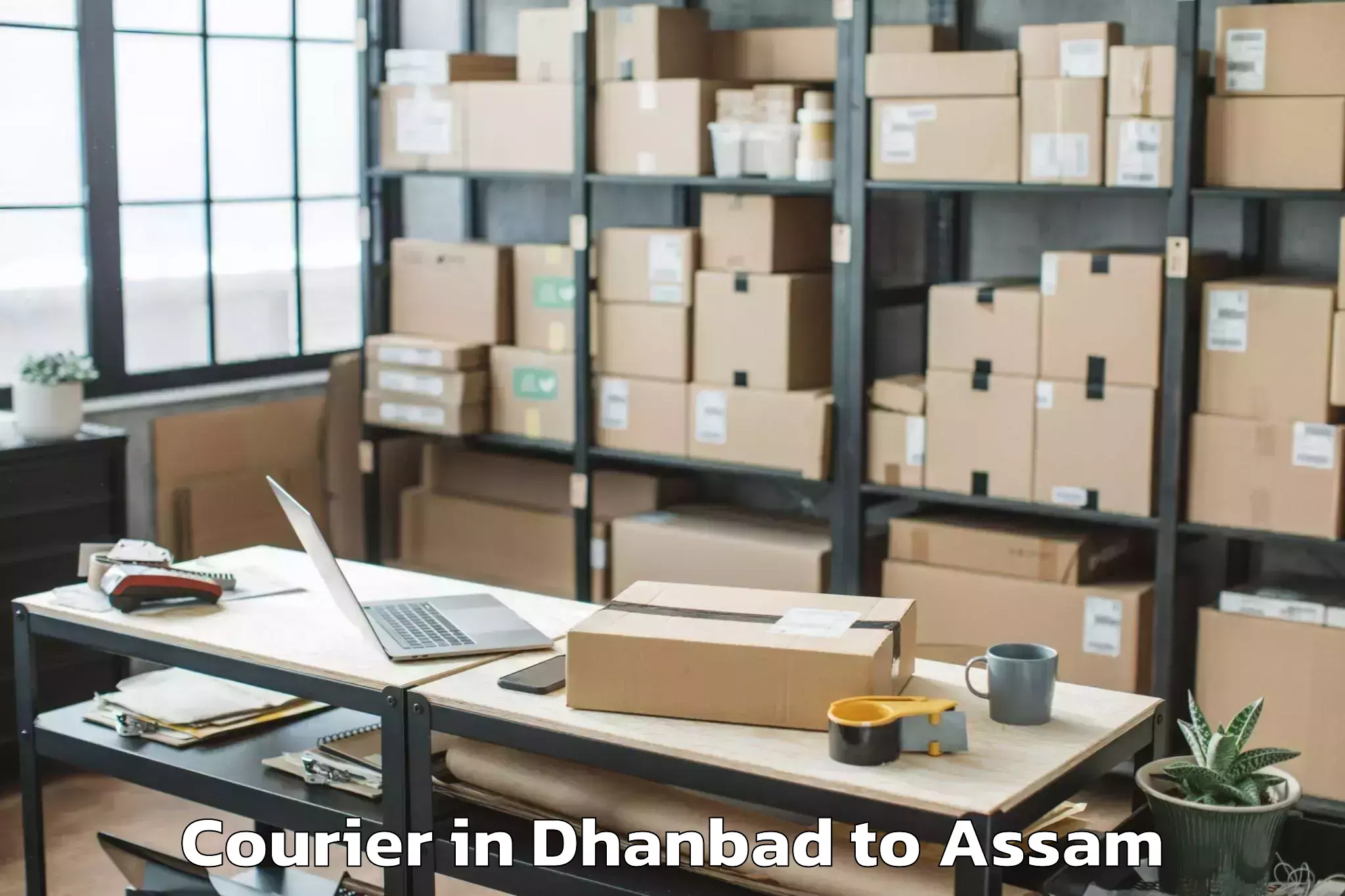 Book Dhanbad to Chariduar Courier Online